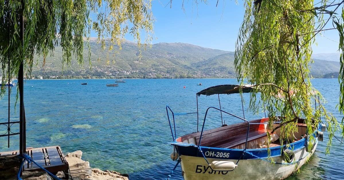 A wooden boat on the glassy waters of Lake Ohrid, North Macedonia's UNESCO-listed crown jewel. Photo by Lucy Arundell