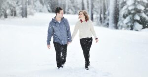 Couple walking on snow. Photo by Yuriy Bogdanov, Unsplash