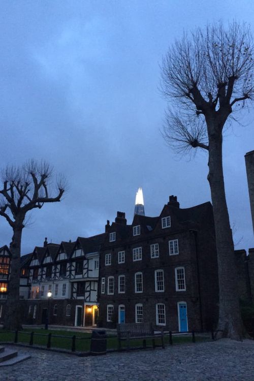 Evening at the Tower of London with a glimpse of the holiday lighting of The Shard in the background