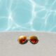 Sunglasses beside pool. Photo by David Lezcano, Unsplash