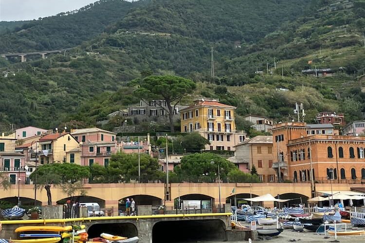 Trains pass along bridge tunneling through massive rocks. Photo by Mari S. Gold