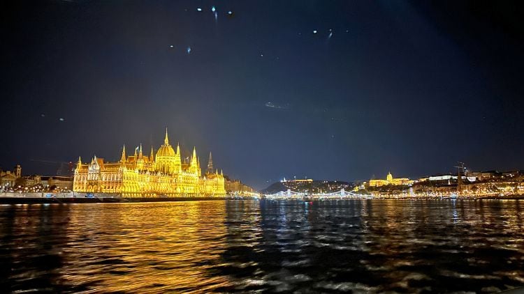 View of Budapest lit up at night from Prosecco cruise. Photo by Isabella Miller