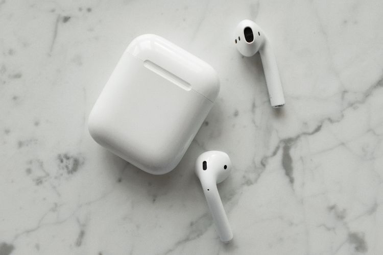 AirPods are a great, compact travel tech gadget. Photo by Canva
