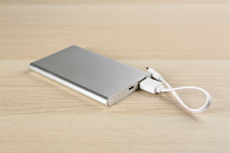 Portable chargers are essential travel gadgets. Photo by Canva