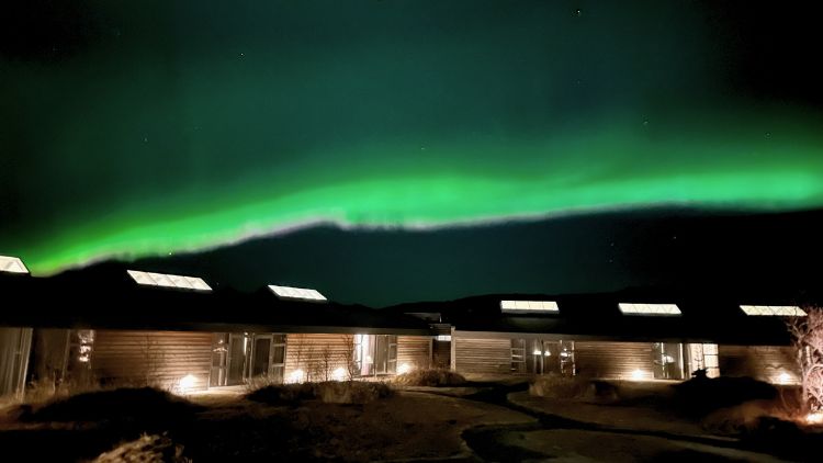 Streak of green Northern Lights painted accross the sky over Hotel Húsafell . Photo by Isabella Miller