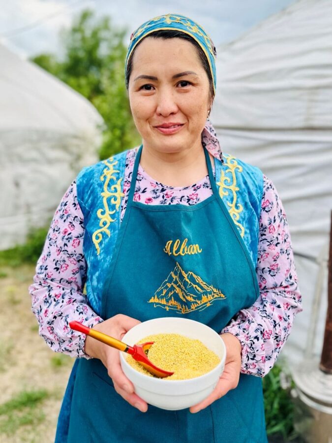 Hostess of Alban Guesthouse in front of yurt where cooking demonstrations take place