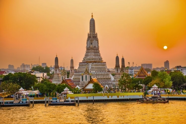 Wat Arun in Bangkok at Sunset. Photo by pavlovakhrushev via Canva