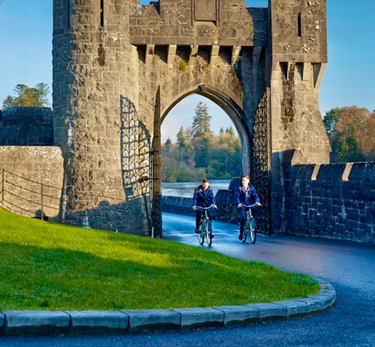 Cycling through the gates of Ashford Castle