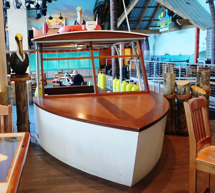 Boat-shaped tables carry the beach scene décor forward in the Margaritaville Restaurant in Hollywood, Florida