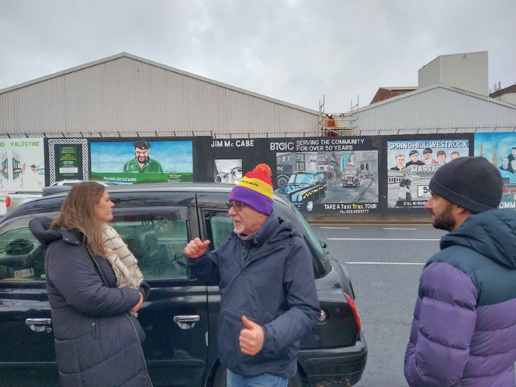 Our Cabbie tells us about the wall murals in Belfast. Photo by Eric D. Goodman