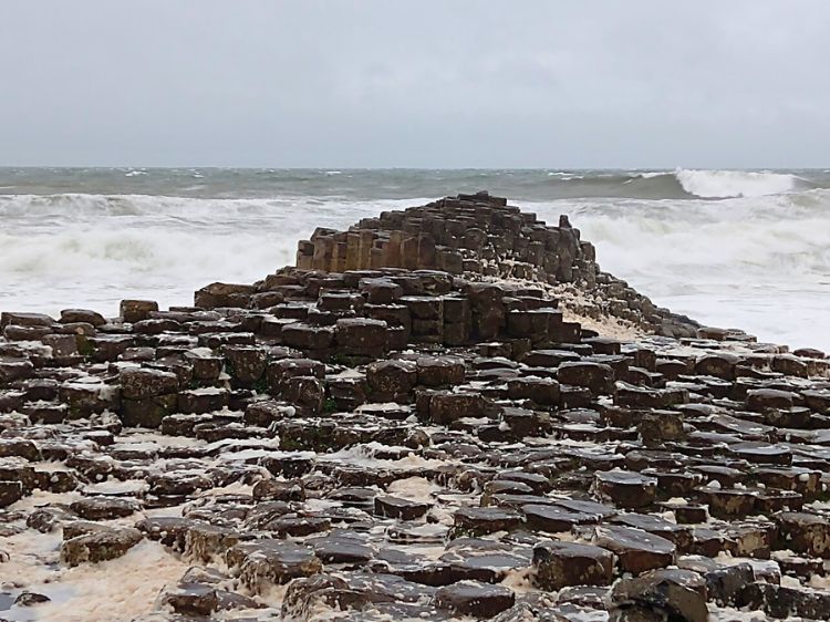 The unusual rock formations of Giant's Causeway on a windy, sudsy day. Photo by Eric D. Goodman
