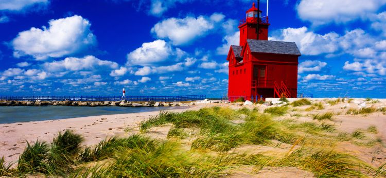 Big red lighthouse in Holland Michigan State Park. Photo by Vito Palmisano
