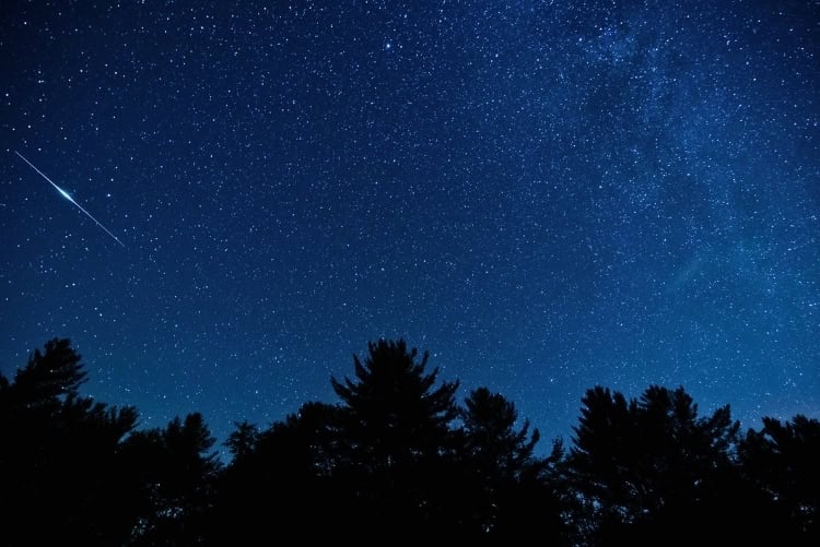The Milky Way stretches across the night sky above the forests of Western North Carolina, where dark skies and high elevation make for exceptional stargazing. Photo by skiserge1 via iStock