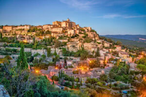 The medieval French town of Gordes at sunset. Photo by Robson Abbott from Getty Images via Canva