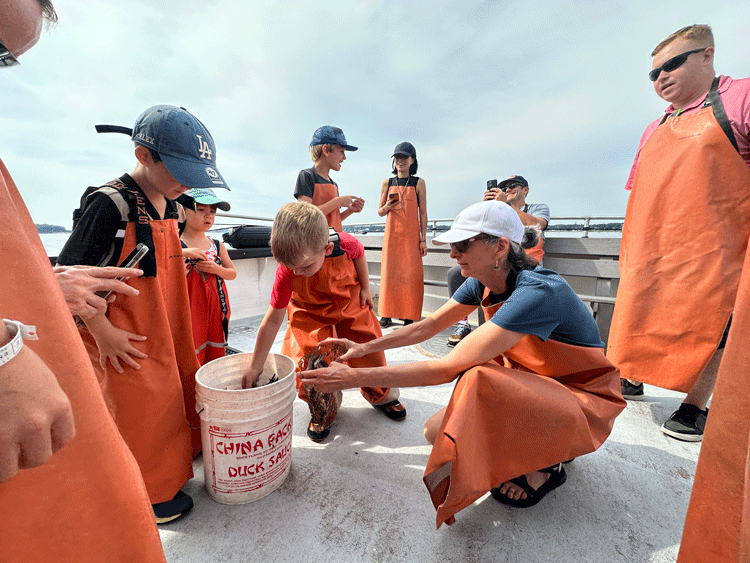 Kids enjoy learning about lobster on a tour with Lucky Catch in Portland. Photo by Janna Graber