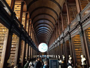 The real Long Room Library at Trinity College, wiht the Gaia Installation (a hovering globe) in the distance