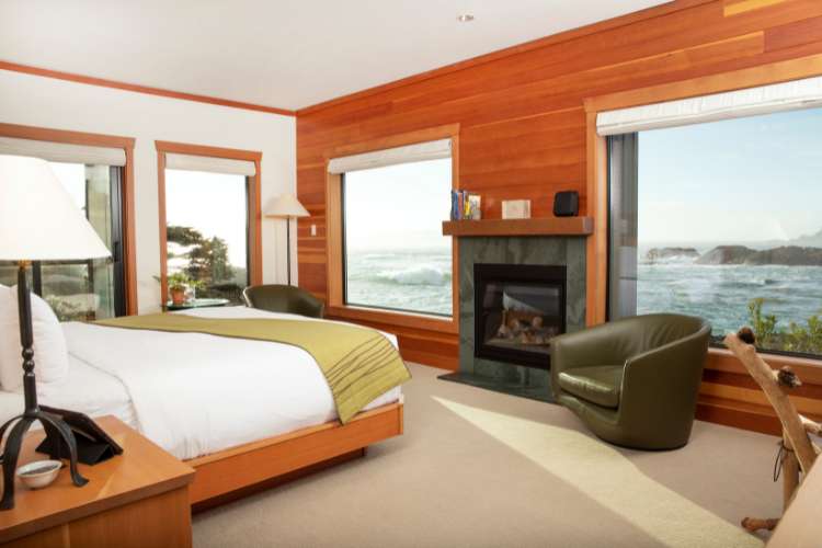 A hotel room with an ocean view and fireplace.