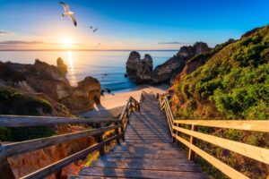 This beach in Portugal's Algarve region is one of many breathtaking beaches found throughout Europe. Image by DaLiu from Getty Images via Canva