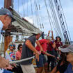 The author (reverse ballcap) and others help to raise the main sail on the 114' schooner Manitou
