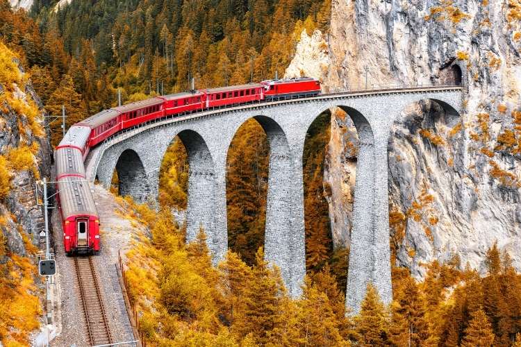 Glacier Express train traveling through the Swiss Alps.
