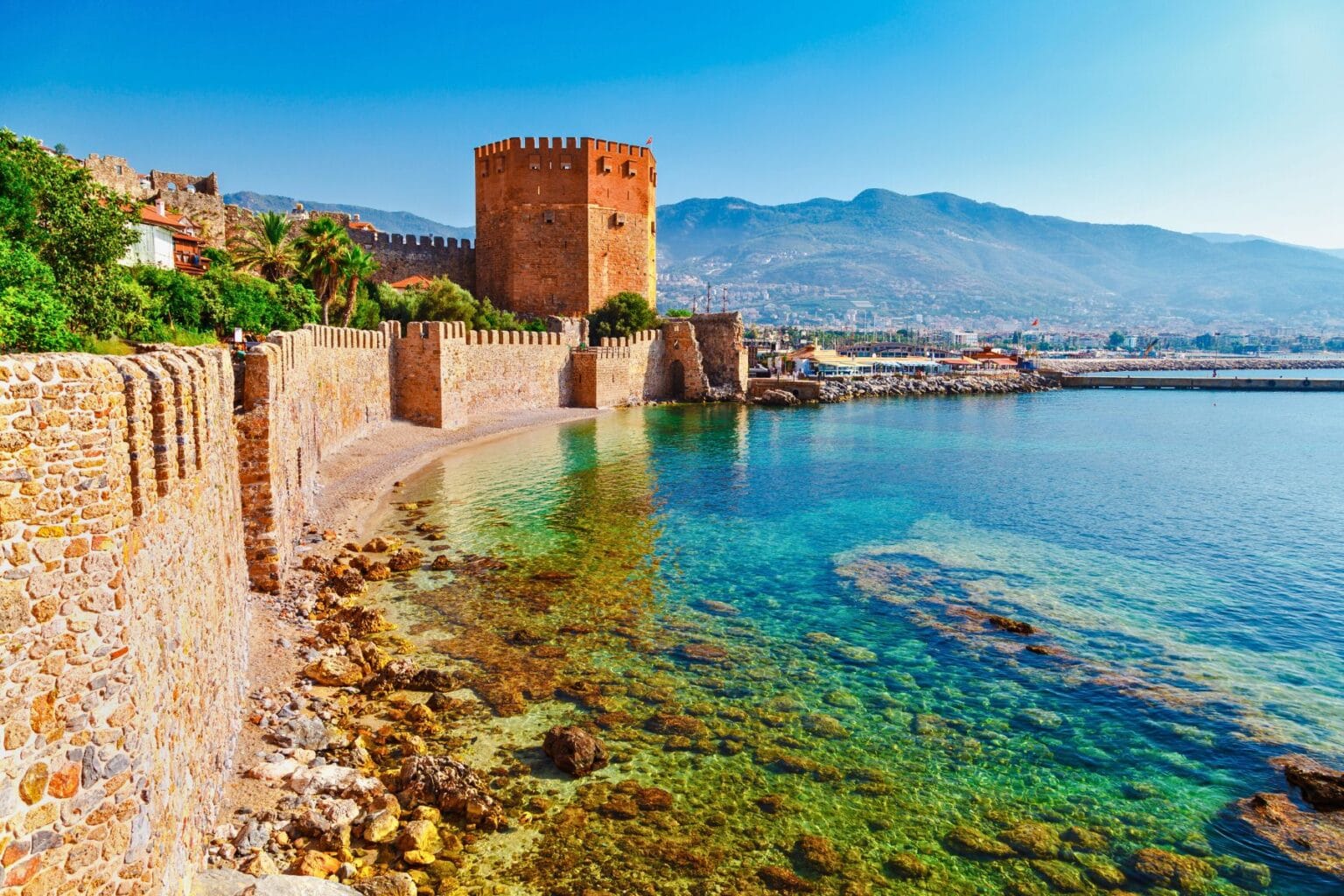 Antalya's coastline stretches beneath the dramatic Taurus Mountains, drawing 17 million visitors annually. Photo by Canva
