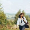 Happy woman traveling. Photo by Getty Images for Unsplash +