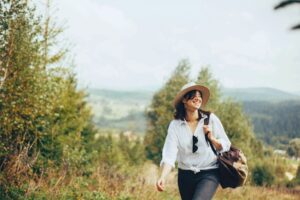 Happy woman traveling. Photo by Getty Images for Unsplash +