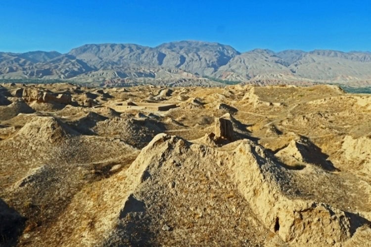 Sprawling ruins of the ancient Sogdian city of Panjakent in Tajikistan, featuring hardened-mud structures.