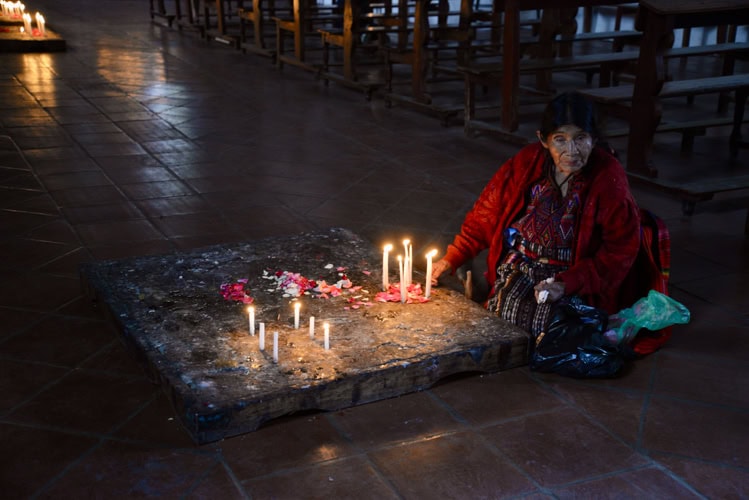A devotee in front of one of Antigua's many churches
