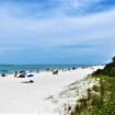 Tourists enjoying the Vanderbilt beach in Naples, Florida.