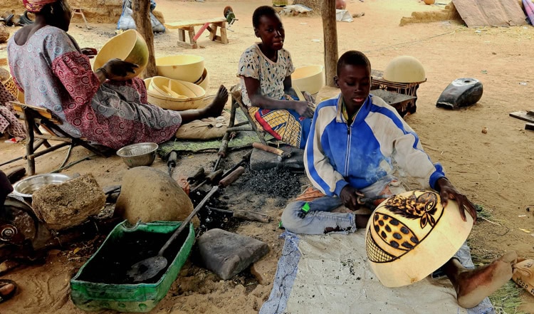 In Noumouwere village, Mali, artists working with hot irons decorate gourds and sell them for household use and wedding presents