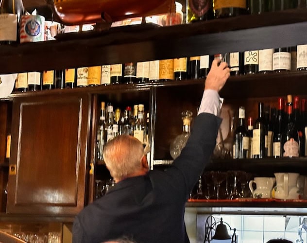 “The Bear” reaches to retrieve memorable bottles.