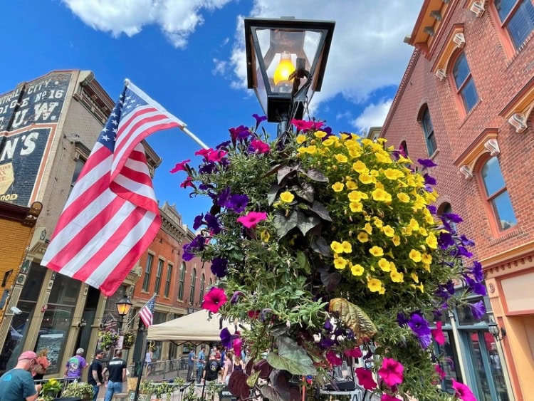 Central City makeover with newly painted buildings, flower baskets, historic lampposts, and new shops and antique stores.