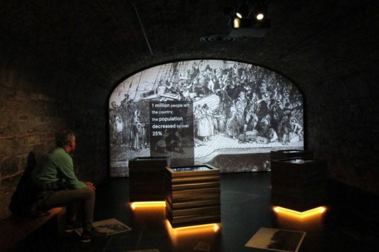 A visitor inside EPIC The Irish Emigration Museum watches a film about emigrant experiences.