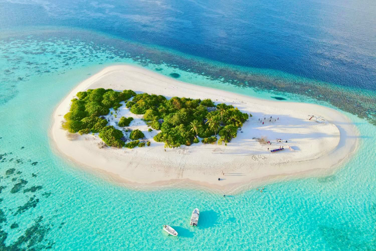 Overwater villas and vibrant coral reefs make the Maldives a bucket list essential for luxury seekers and underwater explorers alike