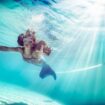 Girl with mermaid tail under water