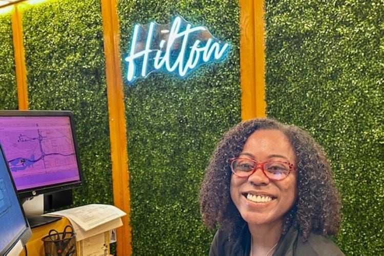 Tressa tosses sunshine at Hilton’s reception desk.