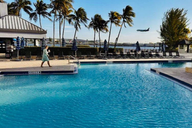 Watch flights land from poolside at Hilton.