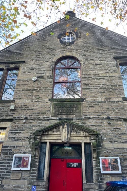 A view of the outside of the Trades Club, showcasing its architecture and surroundings
