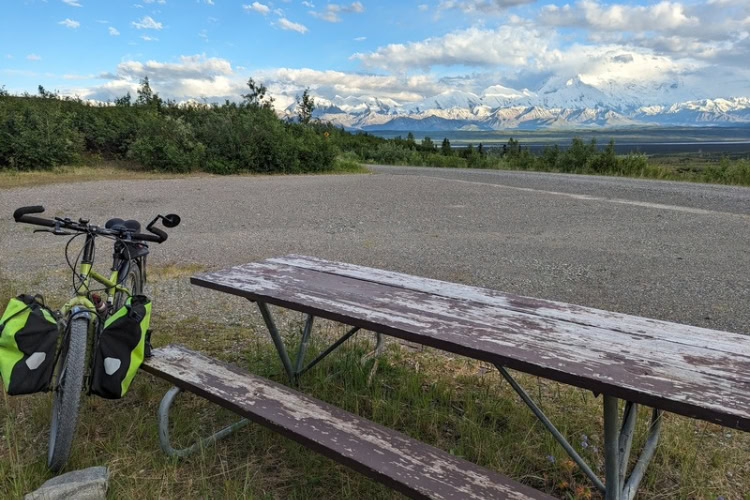 Picnic table near Wonder Lake with a view of Denali and unstaffed ranger cabins due to the Pretty Rocks landslide