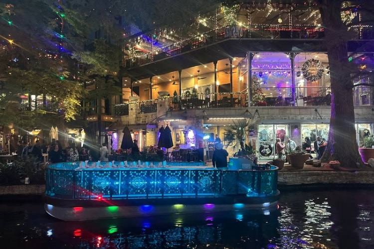 The San Antonio River Walk lit up at night.