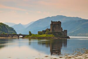 Eilean Donan Castle on Loch Duich—gateway to Scotland's Great Glen, where centuries-old castles and pristine lochs define the Highland cruise experience. Photo by Juergen Schonnop via Canva