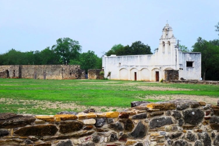 The grounds and church of Mission San Juan Capistrano with a two-tiered espadaña belfry