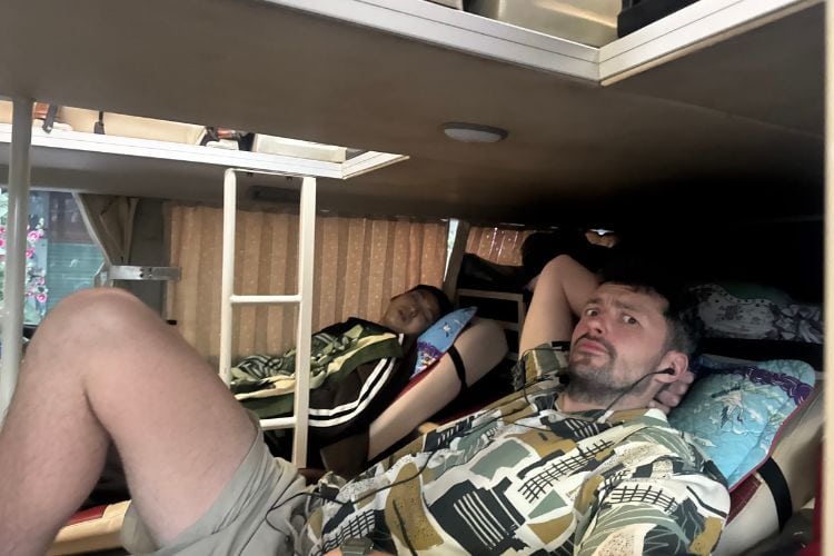 Person laying in a sleeper bus in Vietnam