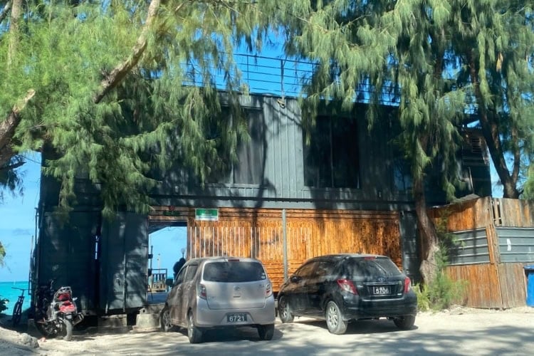 Several repurposed shipping containers serve as popular restaurants and bars on the beach