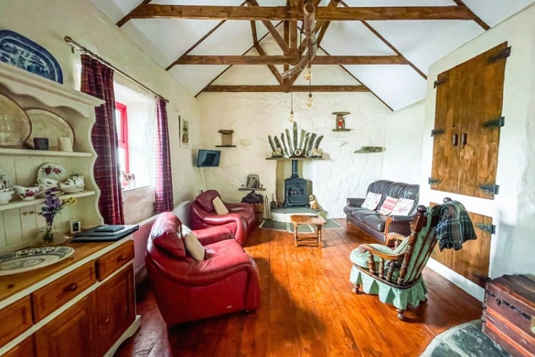 Living room with a peat-burning stove in a rental cottage in Donegal