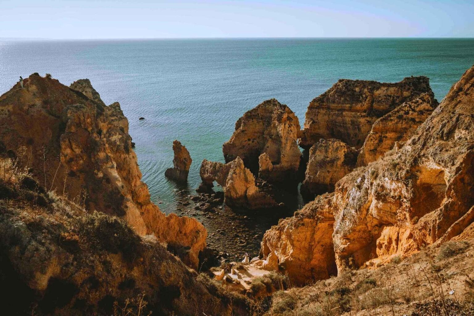 Portugal's dramatic Algarve coastline near Lagos—where retirees find both inspiration and reinvention. Photo by Davey Gravy, Unsplash