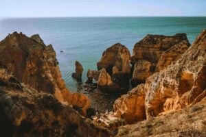 Portugal's dramatic Algarve coastline near Lagos—where retirees find both inspiration and reinvention. Photo by Davey Gravy, Unsplash