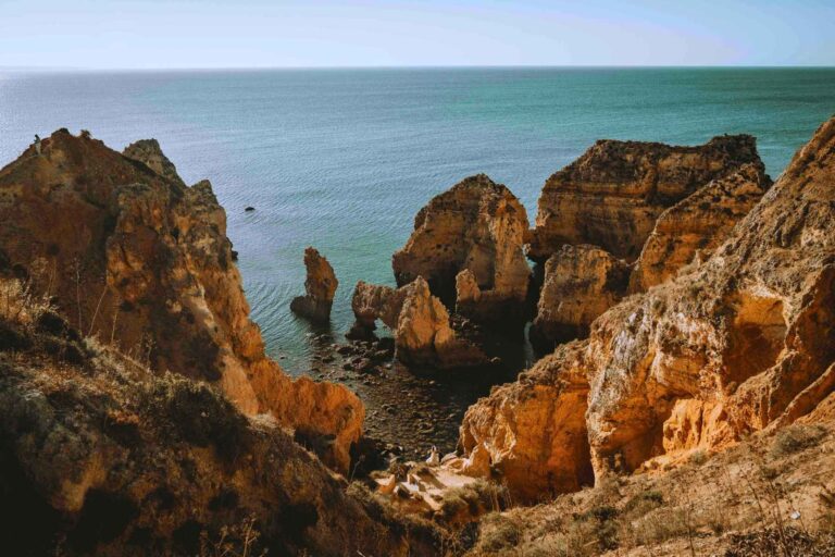 Portugal's dramatic Algarve coastline near Lagos—where retirees find both inspiration and reinvention. Photo by Davey Gravy, Unsplash