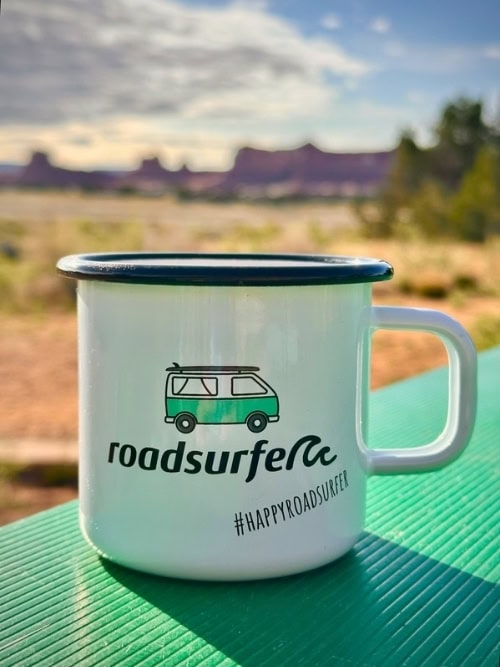 Enjoying a hot beverage from a Roadsurfer mug at The Needles Campground in Canyonlands National Park